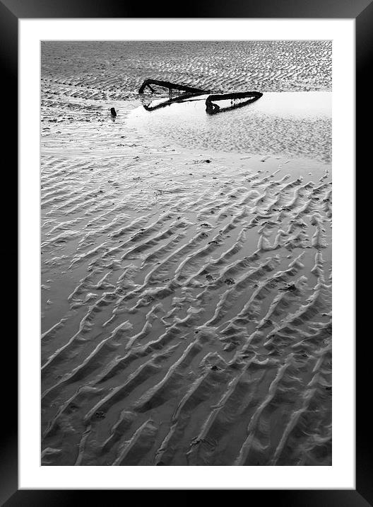 Metal embedded in the sand at low tide. Framed Mounted Print by Liam Grant