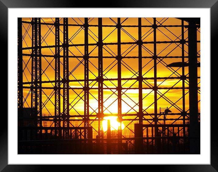 Sunset through gas holder Framed Mounted Print by Andy Huntley