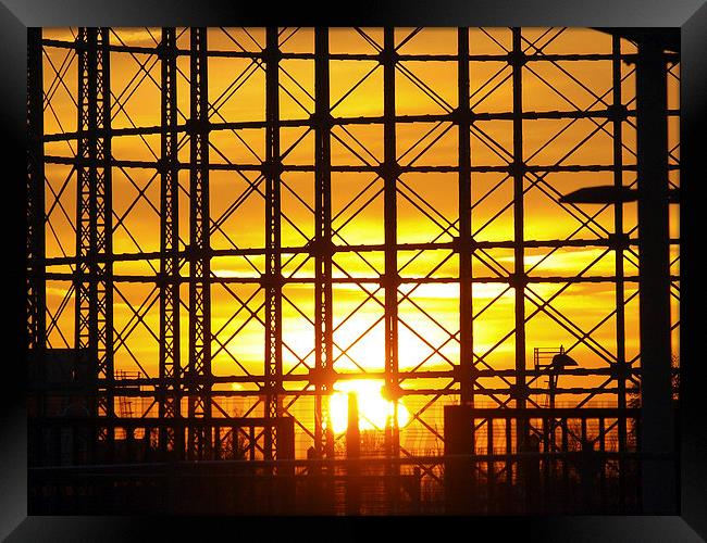 Sunset through gas holder Framed Print by Andy Huntley