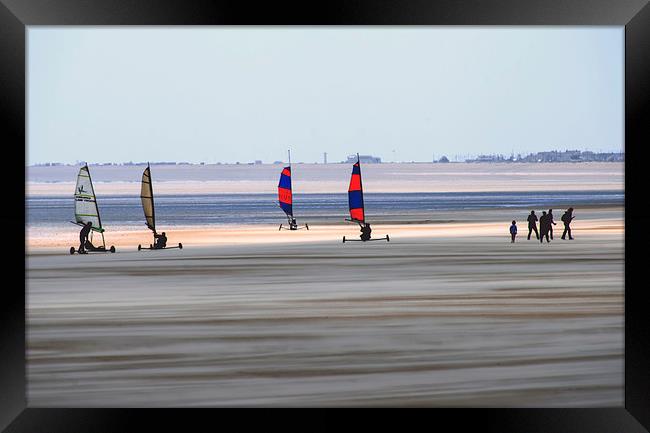 Wind Sand surfers on a stormy day with sand blowin Framed Print by Susan Sanger