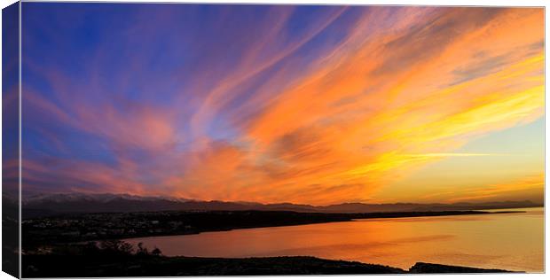 Dramatic vivid orange sunset over a marine bay Canvas Print by Nikos Vlasiadis