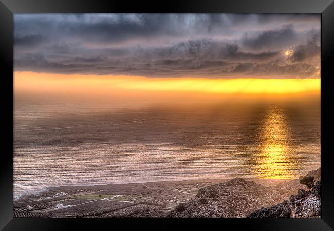 Reflection on the ocean from an orange sunset Framed Print by Nikos Vlasiadis