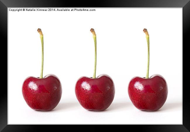 Three Red Cherries against a White Background Framed Print by Natalie Kinnear
