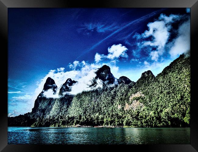 Huts dwarfed by mountains Framed Print by Simon Joshua Peel