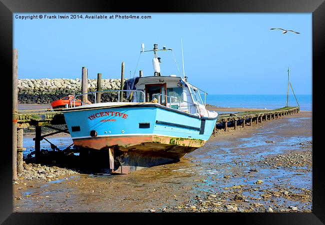 A fishing boat sits high and dry in Rhos-on-Sea Framed Print by Frank Irwin