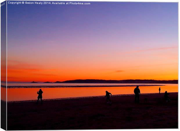 Playing on the beach at sundown Canvas Print by Gwion Healy