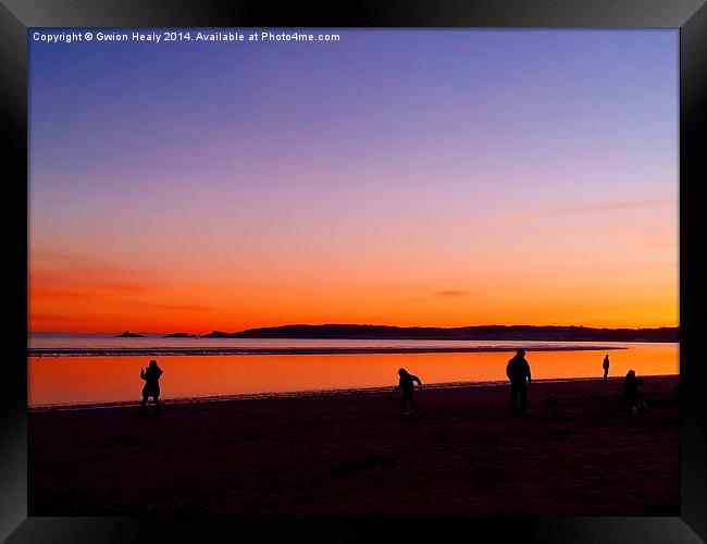 Playing on the beach at sundown Framed Print by Gwion Healy