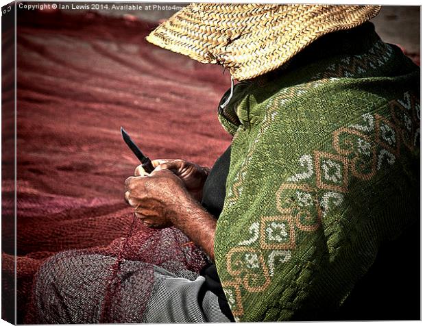 Fisherman Mending Nets at Essaouira Canvas Print by Ian Lewis