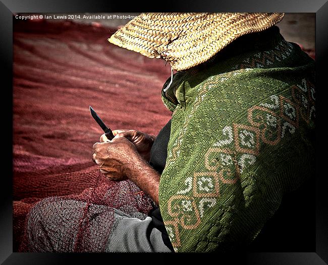 Fisherman Mending Nets at Essaouira Framed Print by Ian Lewis
