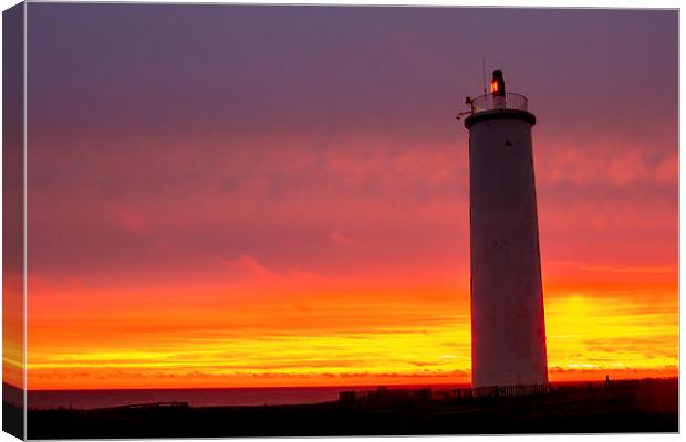 Lighthouse at sunset Canvas Print by Ian Jones