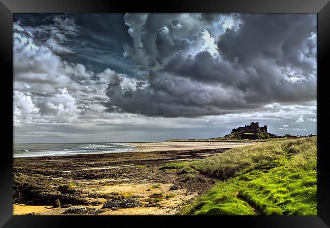 Dramatic skys over Bamburgh Castle and beach Framed Print by Kevin Tate