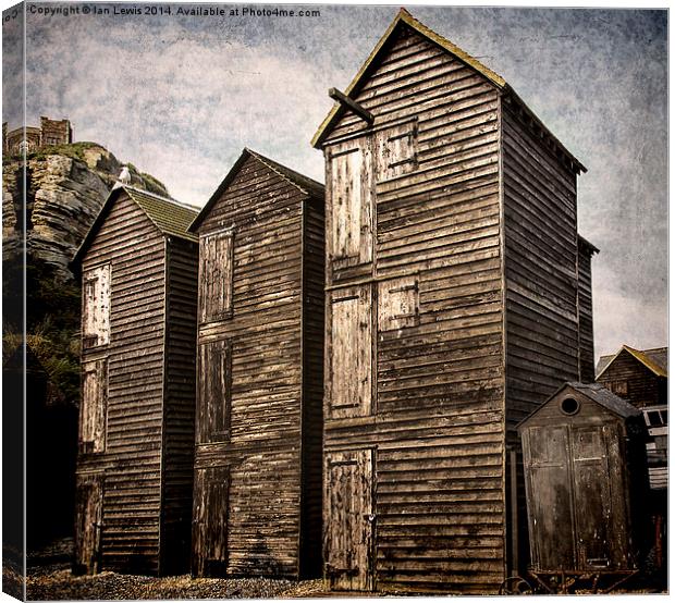 Fishermens Huts at Hastings Canvas Print by Ian Lewis