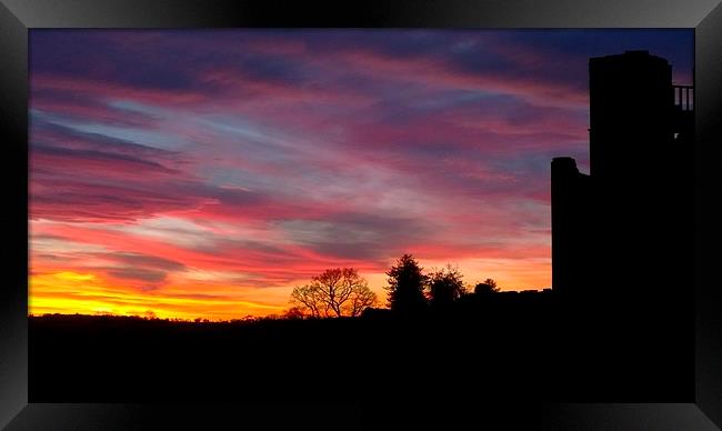 A sunset at Kenilworth Castle Framed Print by John Evans
