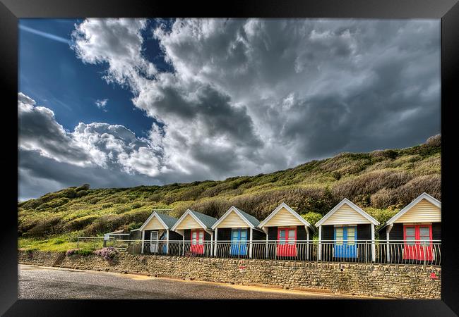 Clouds, beach huts and light Framed Print by Jennie Franklin