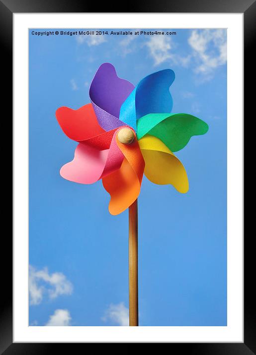 Pinwheel or Windmill Against a Blue Sky Framed Mounted Print by Bridget McGill
