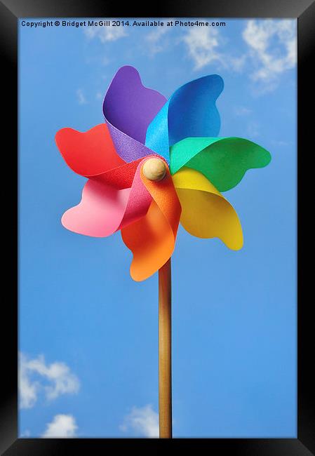 Pinwheel or Windmill Against a Blue Sky Framed Print by Bridget McGill