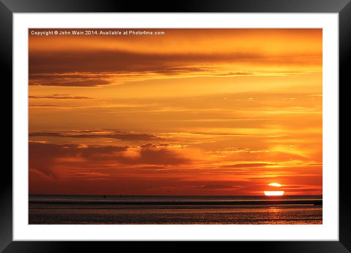 Sun sinking into the Sea. Framed Mounted Print by John Wain