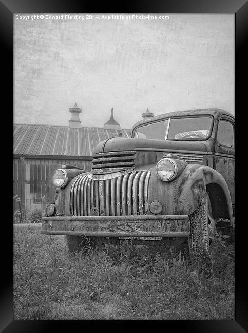 Old farm truck out by the barn Framed Print by Edward Fielding