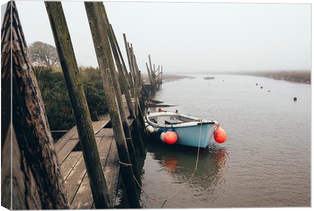 Boats moored at Blakeney in fog. Canvas Print by Liam Grant