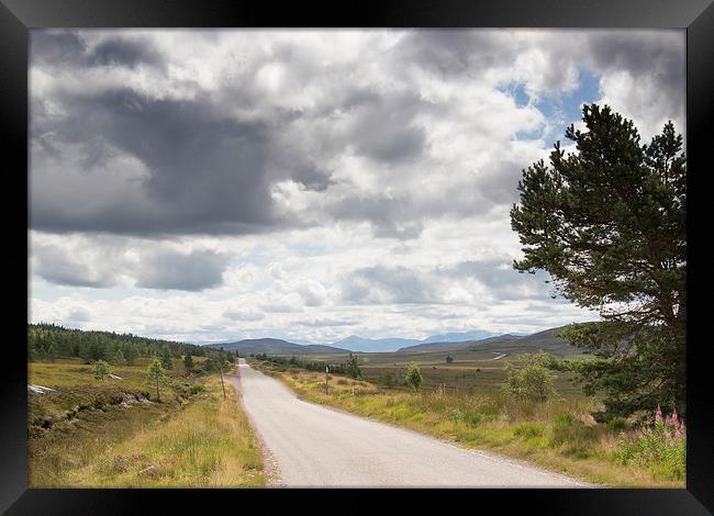  Clouds above remote Highland Road Framed Print by Derek Corner