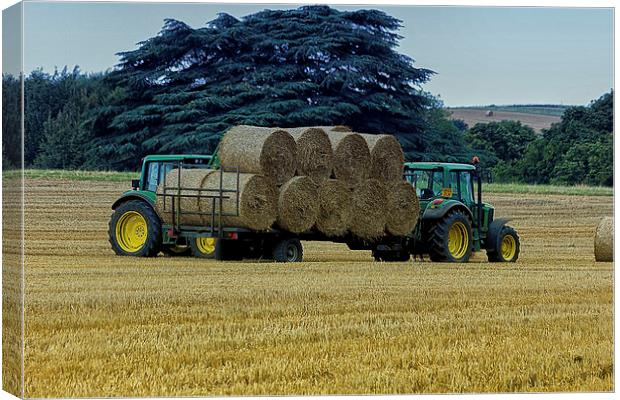  Gathering the hay bales Canvas Print by Dean Messenger