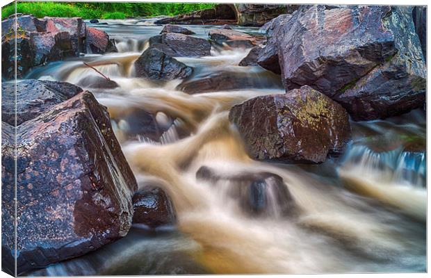 Cascading water over rocks Canvas Print by Jonah Anderson Photography