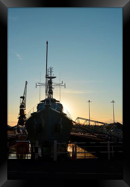 Setting sun Behind HMS Cavalier  Framed Print by Mike Gwilliams