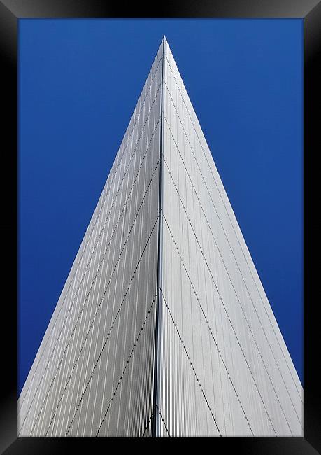 An angular building pierces a blue sky  Framed Print by Jamie Lumley