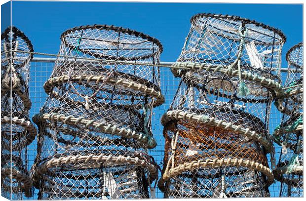  Lobster Pots against a blue sky Canvas Print by Rosie Spooner