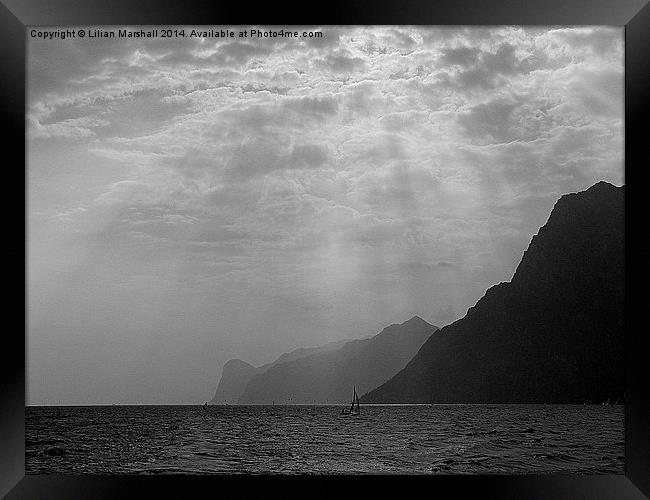 Rays over Lake Garda Framed Print by Lilian Marshall