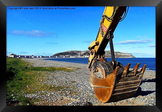  A 'Caterpillar' excavator resting its bucket on t Framed Print by Frank Irwin