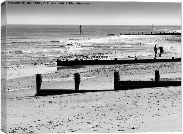 "Just we two" - walkers on Cromer Beach  Canvas Print by john hartley