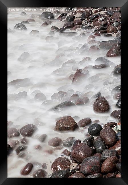Sea washing over rocks Framed Print by Graham Moore
