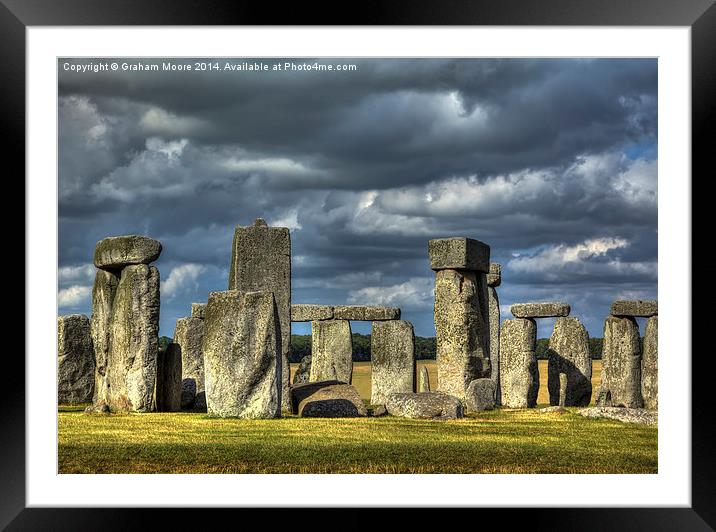 Stonehenge in gathering storm Framed Mounted Print by Graham Moore
