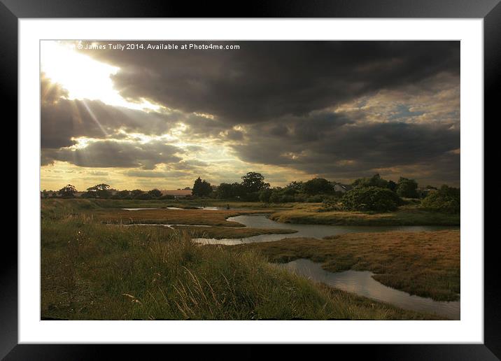 The sun breaks through over the winter saltmarsh Framed Mounted Print by James Tully