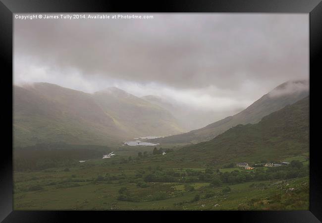  Heavy clouds sit within an Irish valley Framed Print by James Tully