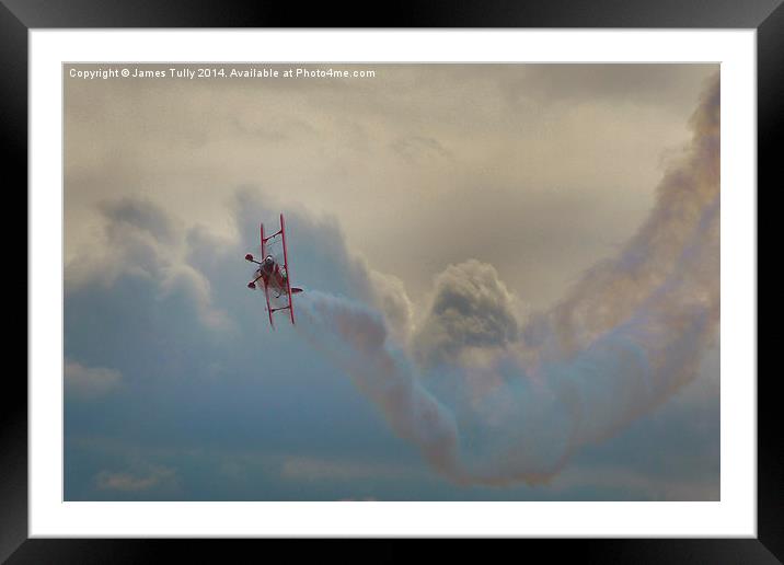 A smoking biplane corksrews in heavy cloud  Framed Mounted Print by James Tully