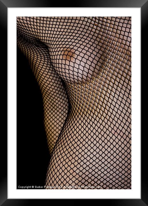 Female torso in net Framed Mounted Print by Gabor Pozsgai