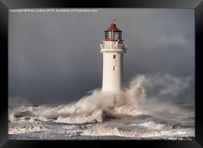 Lighthouse in a storm Framed Print by Rick Lindley