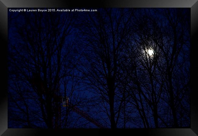 The moon and a crane, at night, through the trees. Framed Print by Lauren Boyce