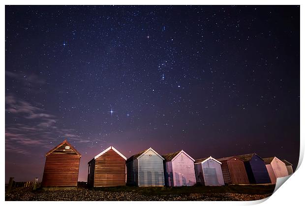 Orion over beach huts Print by Chris Nesbit