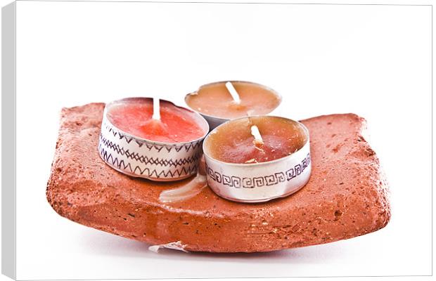 Hand-painted candles on a stone Canvas Print by Gabor Pozsgai