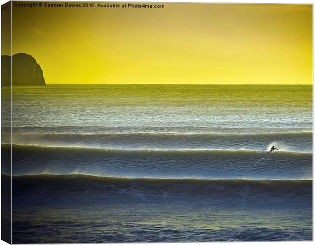  Solo surfing at a Gower beach Canvas Print by Spenser Davies