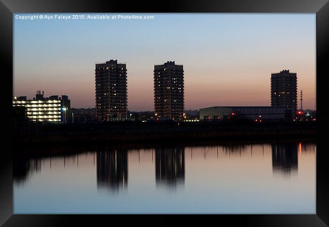 High Rise Buildings and Reflections at dusk Framed Print by Ayo Faleye