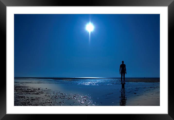 Iron statue silhouette against a clear blue sky Framed Mounted Print by ken biggs