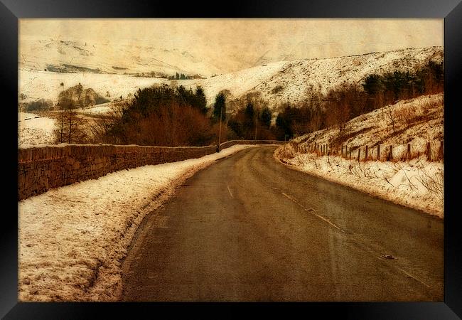 Empty road through snow covered Yorkshire moors Framed Print by ken biggs