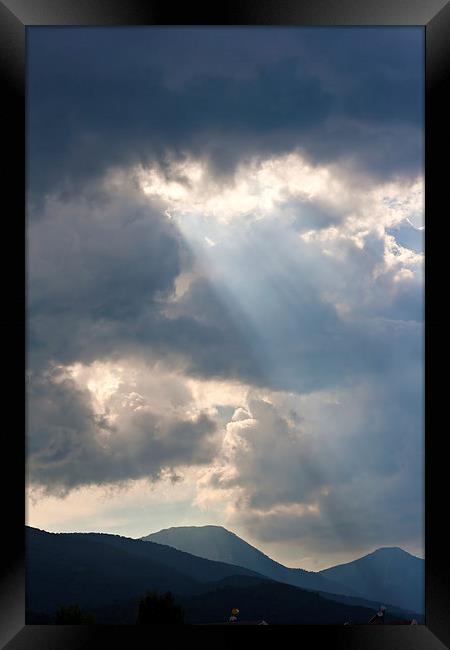 Sun rays through storm clouds Framed Print by ken biggs
