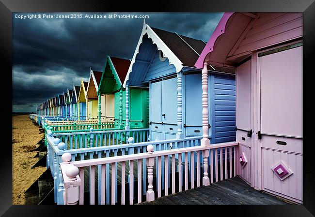  Beach Huts & Storm Clouds Framed Print by Peter Jones