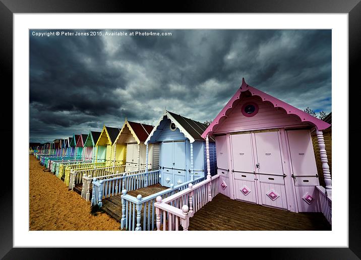 Row of colourful beach shelters.  Framed Mounted Print by Peter Jones