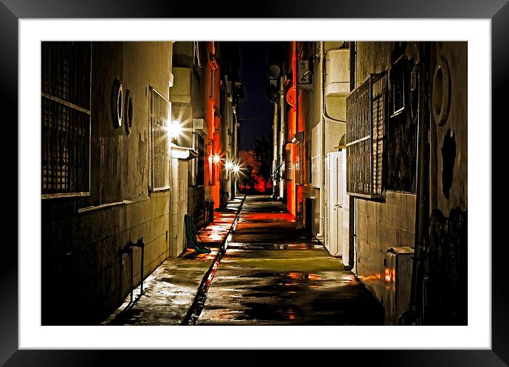 an alley at nightime Framed Mounted Print by ken biggs